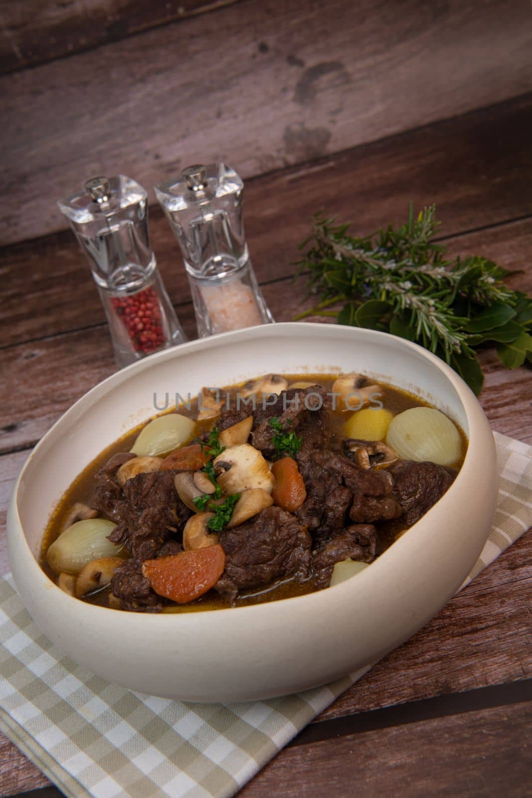 Beef bourguignon recipe, beef stew with wine sauce and vegetables. High quality photo