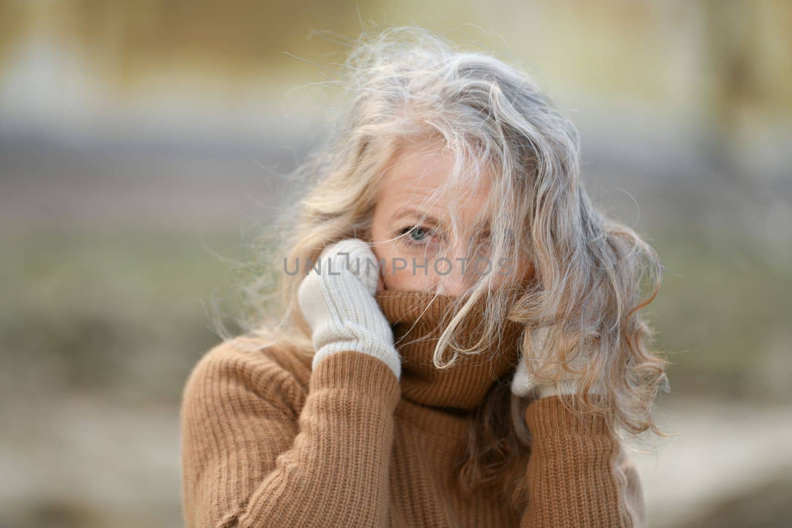 Portrait of a sixty-year-old woman with a grey hair