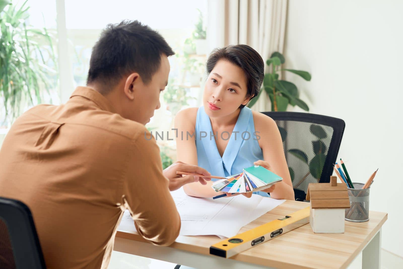 Man and woman working together in an architect office