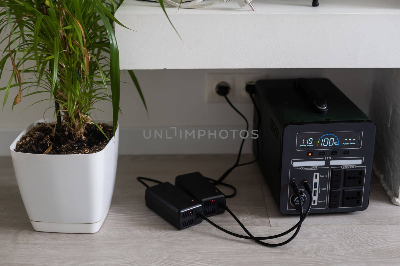 Charging station for gadgets when there is no light during blackout. Generator power bank battery in the absence of electricity. Charge electric rechargeable battery by Andelov13