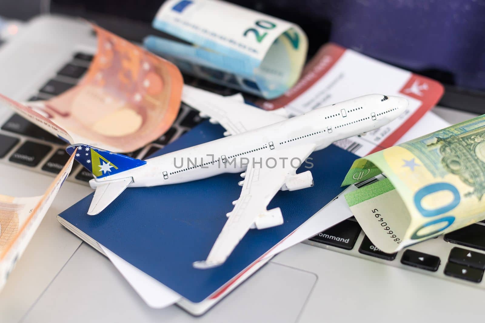 Composition with laptop, toy plane and money on color background. Travel agency by Andelov13