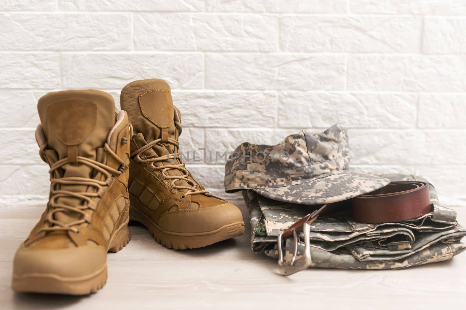 Set of military uniform on wooden background, close up view.