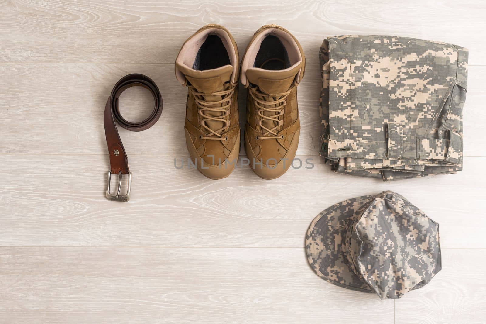 Set of military uniform on wooden background, close up view.