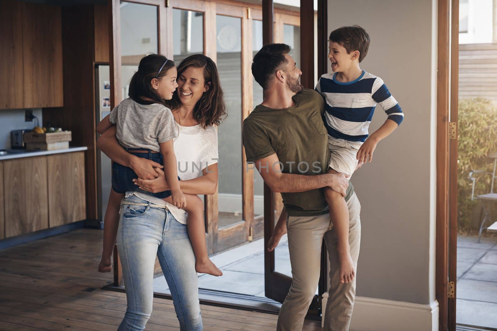 Family time, the most important time. a happy young family spending quality time together at at home. by YuriArcurs