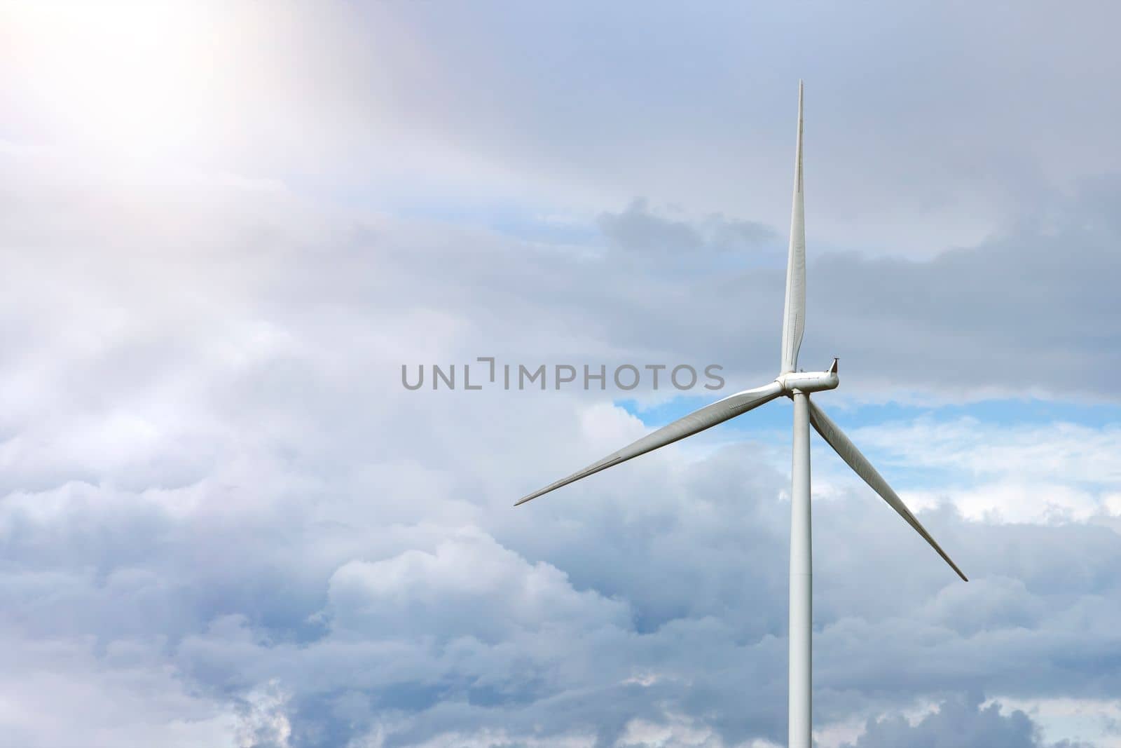 Green wind energy. Windmills for the production of renewable electricity. Windmills in the field, produce electricity on a sunny summer day by SERSOL