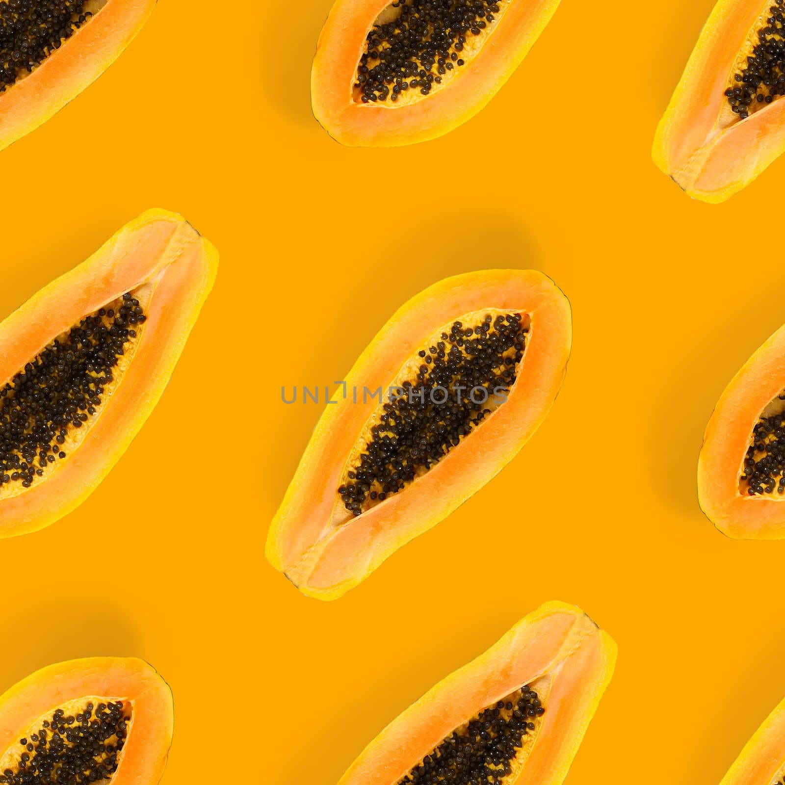 Fresh ripe papaya seamless pattern on orange background. Tropical abstract background. Top view. by PhotoTime