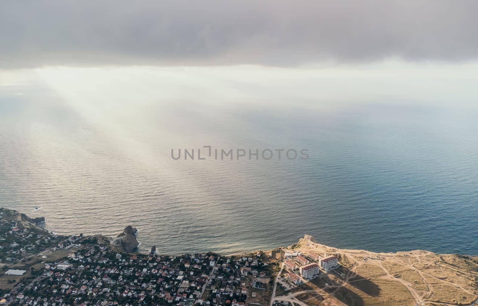 Abstract nature summer or spring ocean sea background. Small waves on water surface in motion blur with bokeh lights from sunrise.