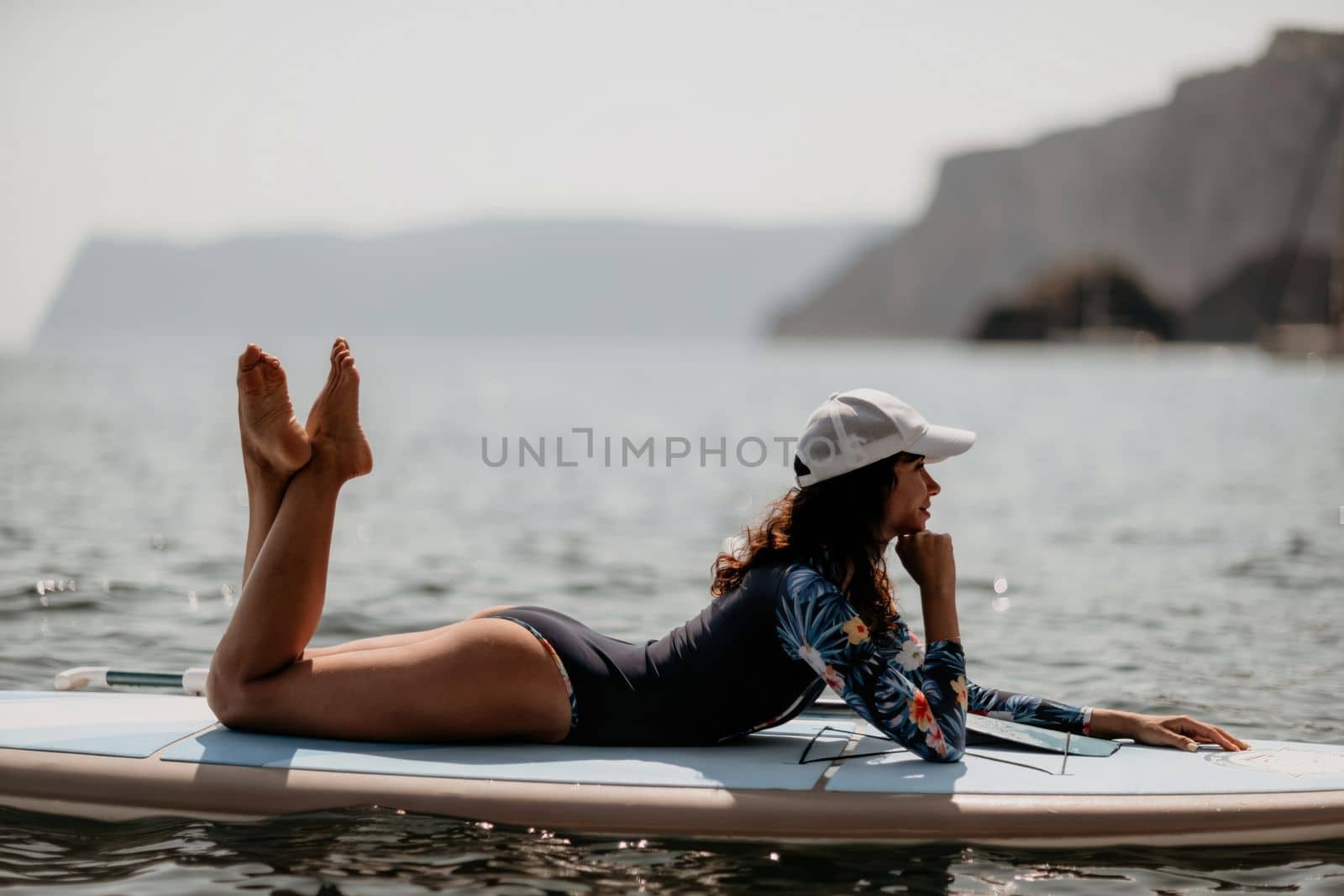 Woman sup yoga. Middle age sporty woman practising yoga pilates by panophotograph