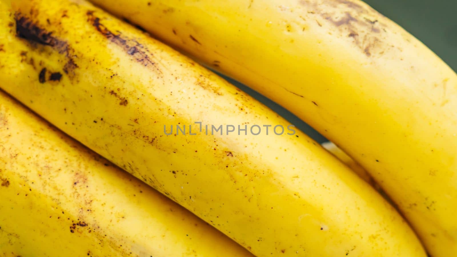 Close up ripe banana skin with brown spots Background peel texture macro photo. Tropical fruit wallpaper sweet bright tasty colour.