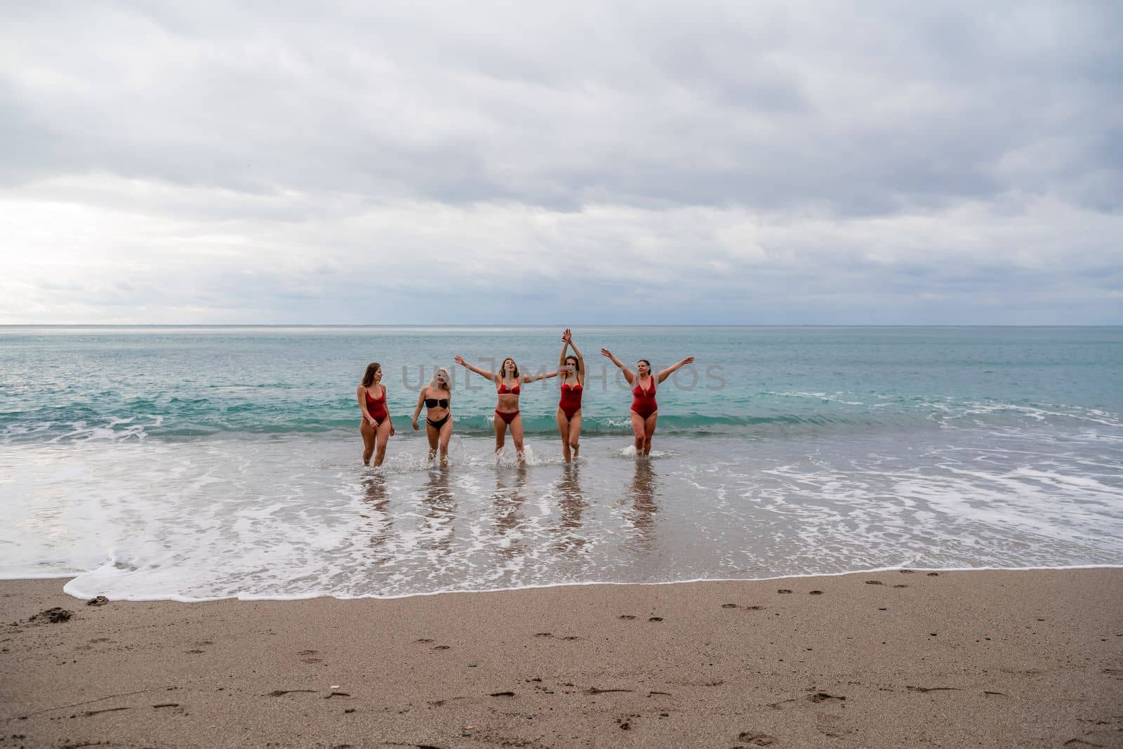 Big happy family or group of five friends is having fun against sunset beach. Beach holidays concept. by Matiunina