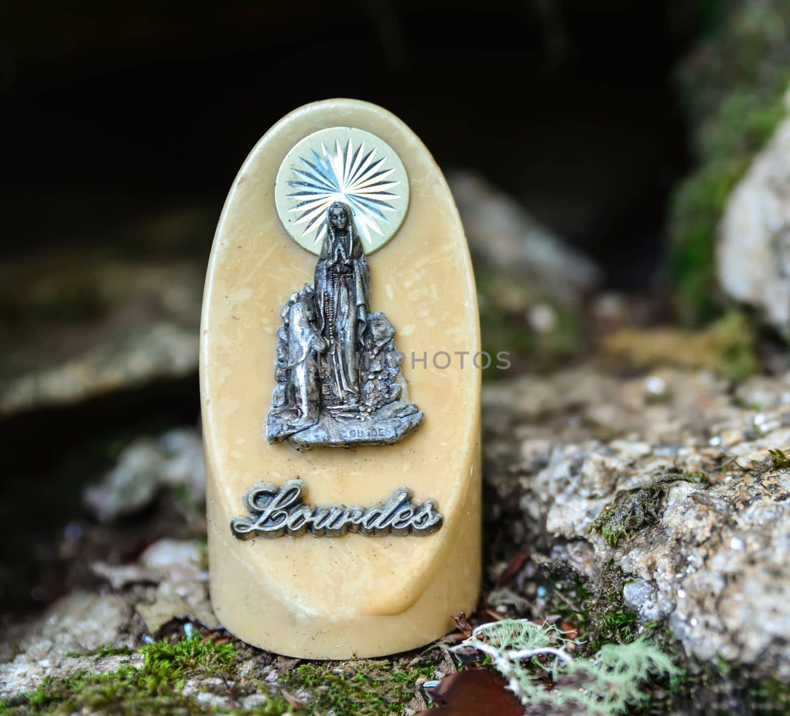 The statue of Our Lady of Lourdes on ivory stone