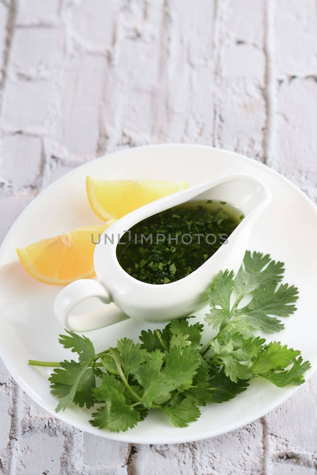 Green delicious herbal marinade of cilantro, basil, parsley, oil, traditional seasoning for salad dressing