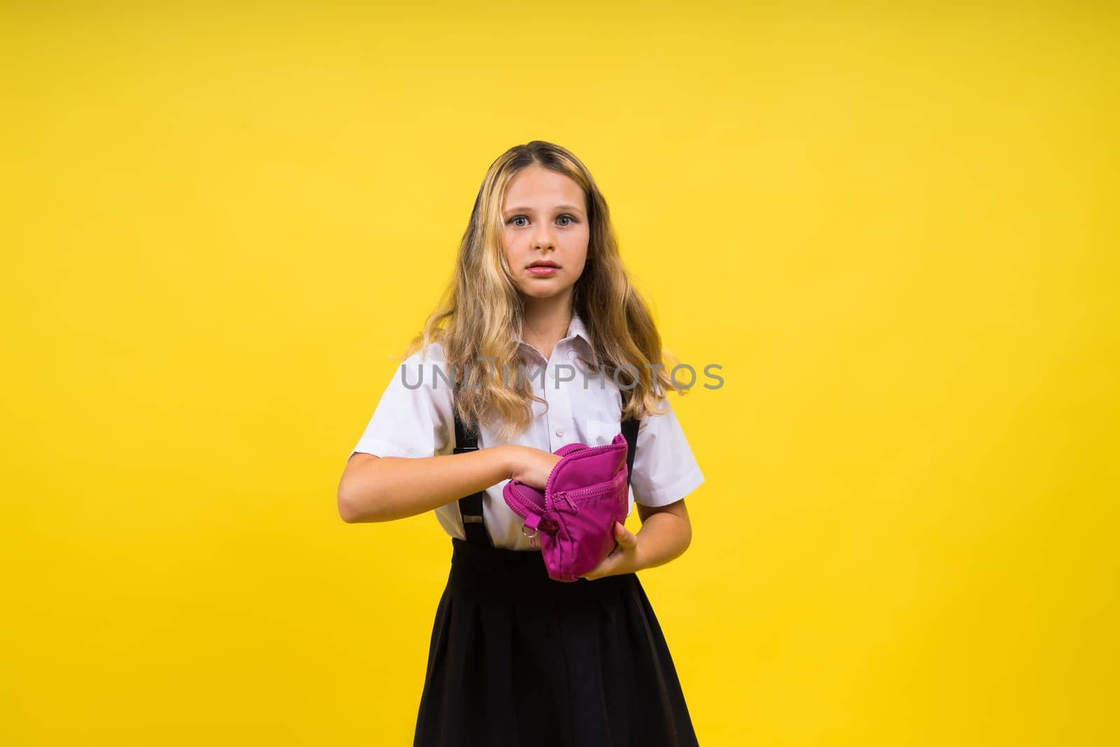 Happy schoolgirl with colored pencils and a pencil case in hand by Zelenin