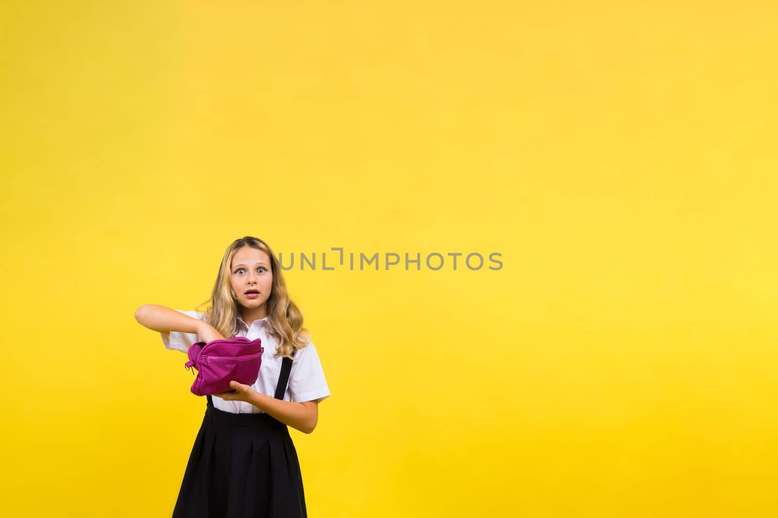 Happy schoolgirl with colored pencils and a pencil case in hand by Zelenin