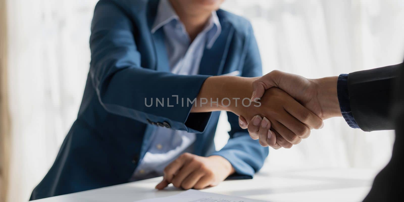 Handshake of cooperation customer and salesman after agreement, successful car loan contract buying or selling new vehicle..