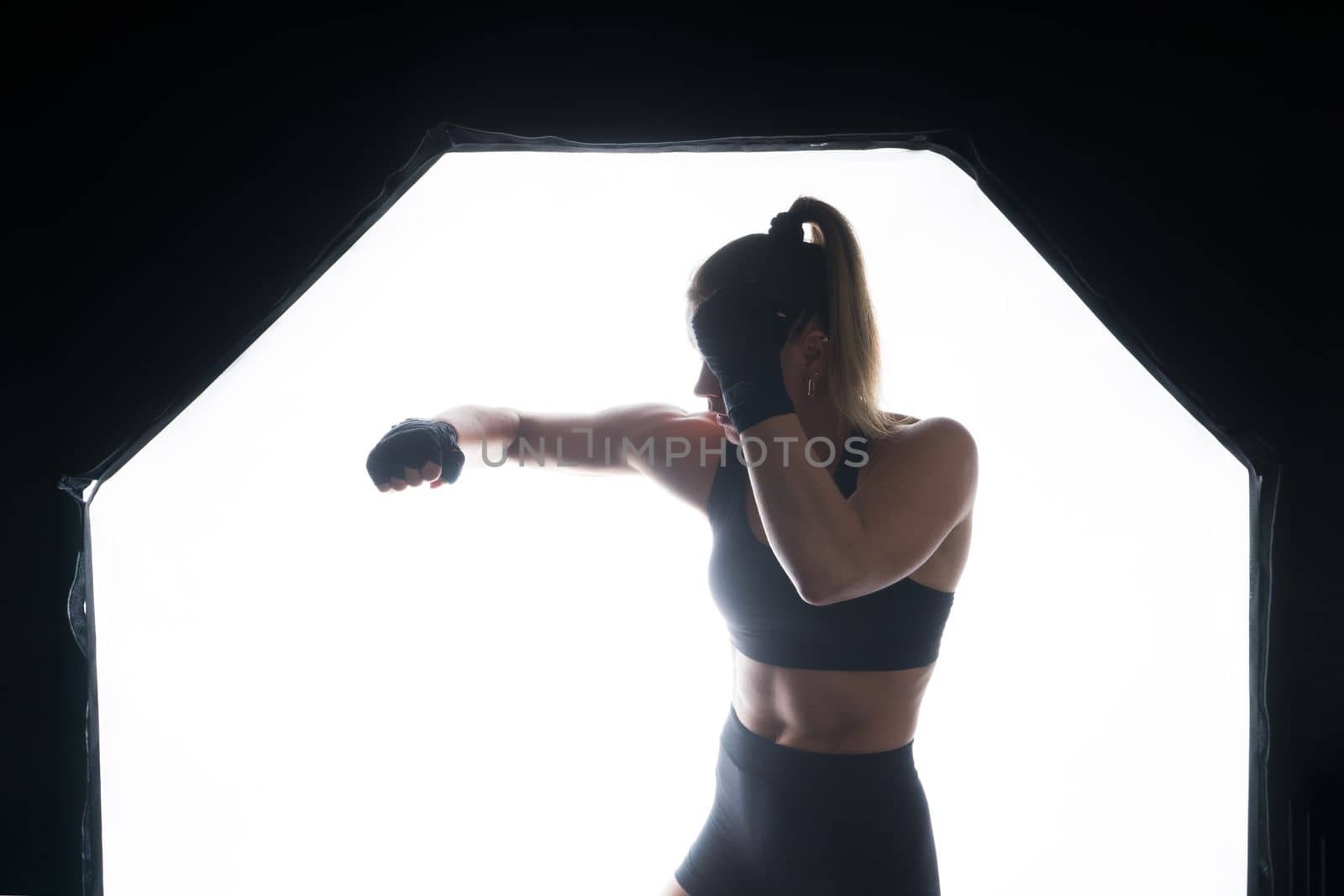 Woman do high kick, tae-bo. Athletic fit female with perfect body kick air, punching with legs by Zelenin