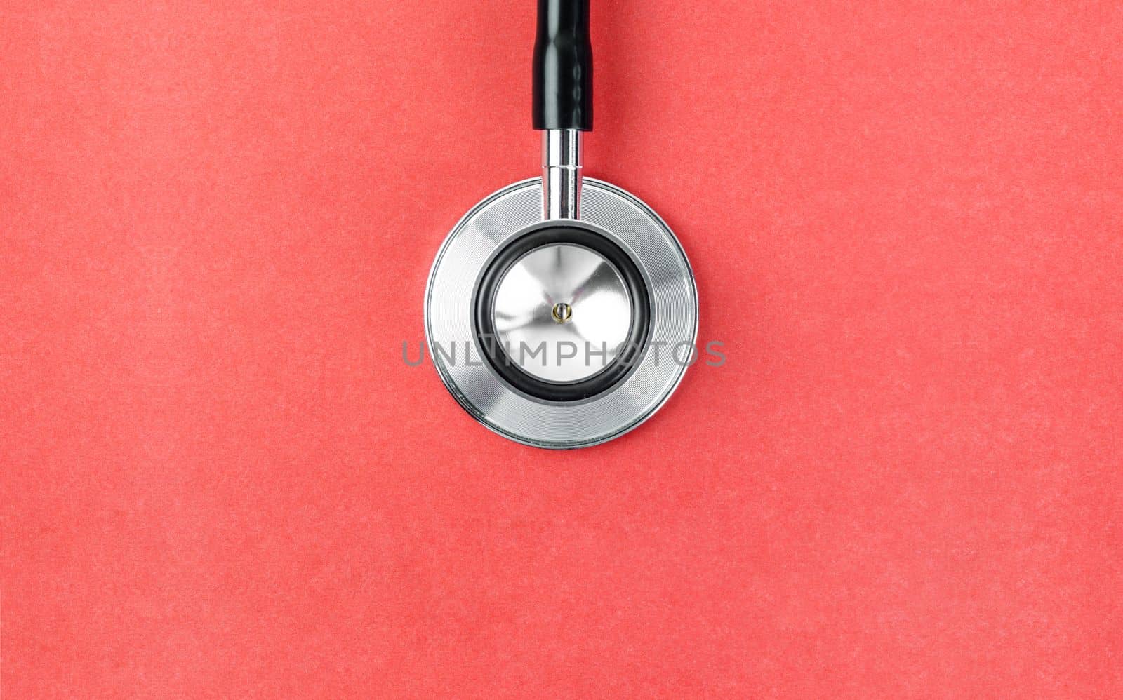 Close up Stethoscope on red background with empty space for your text.