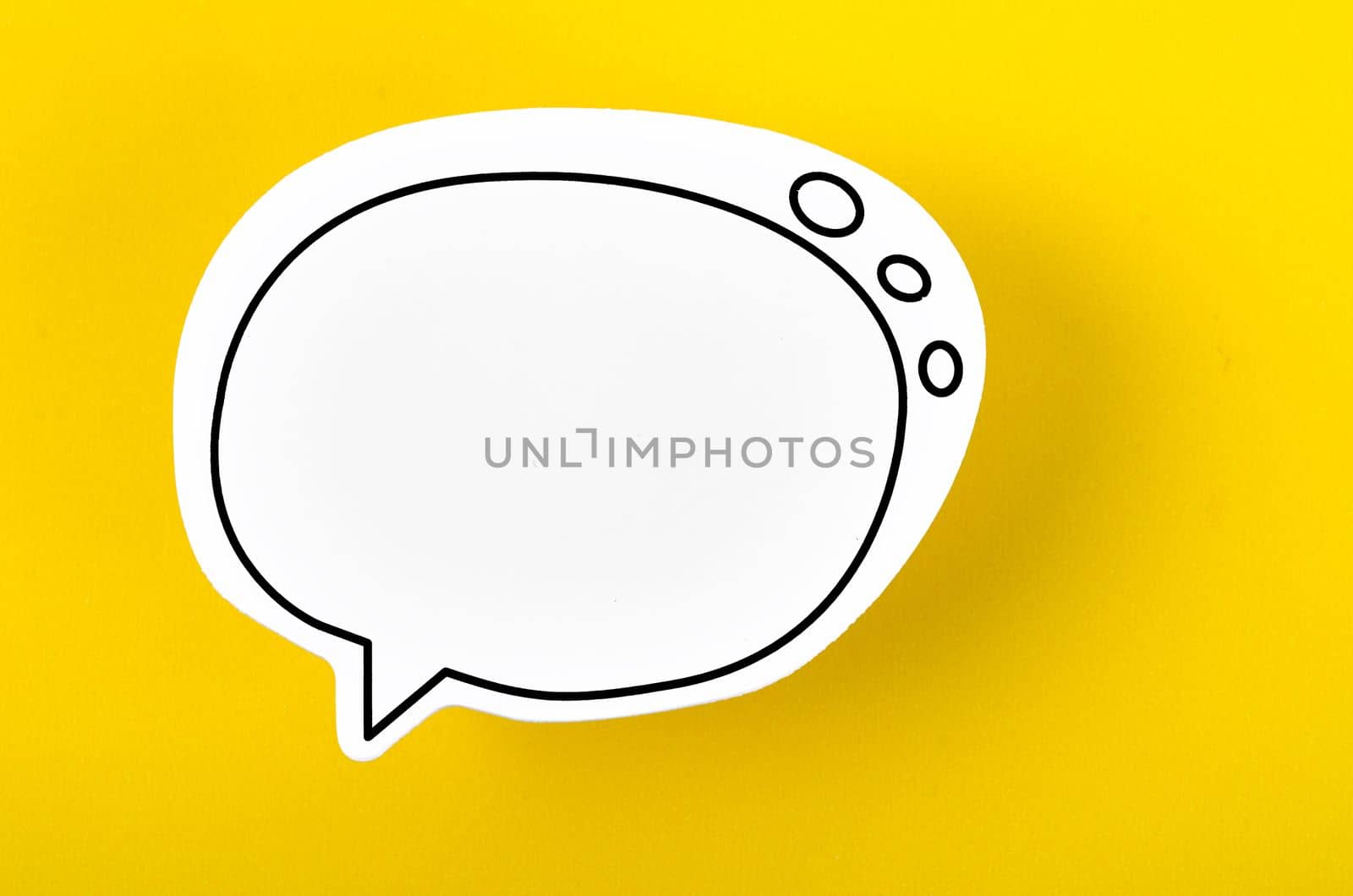 A Speech bubble with copy space communication talking speaking concepts on yellow background. by Gamjai