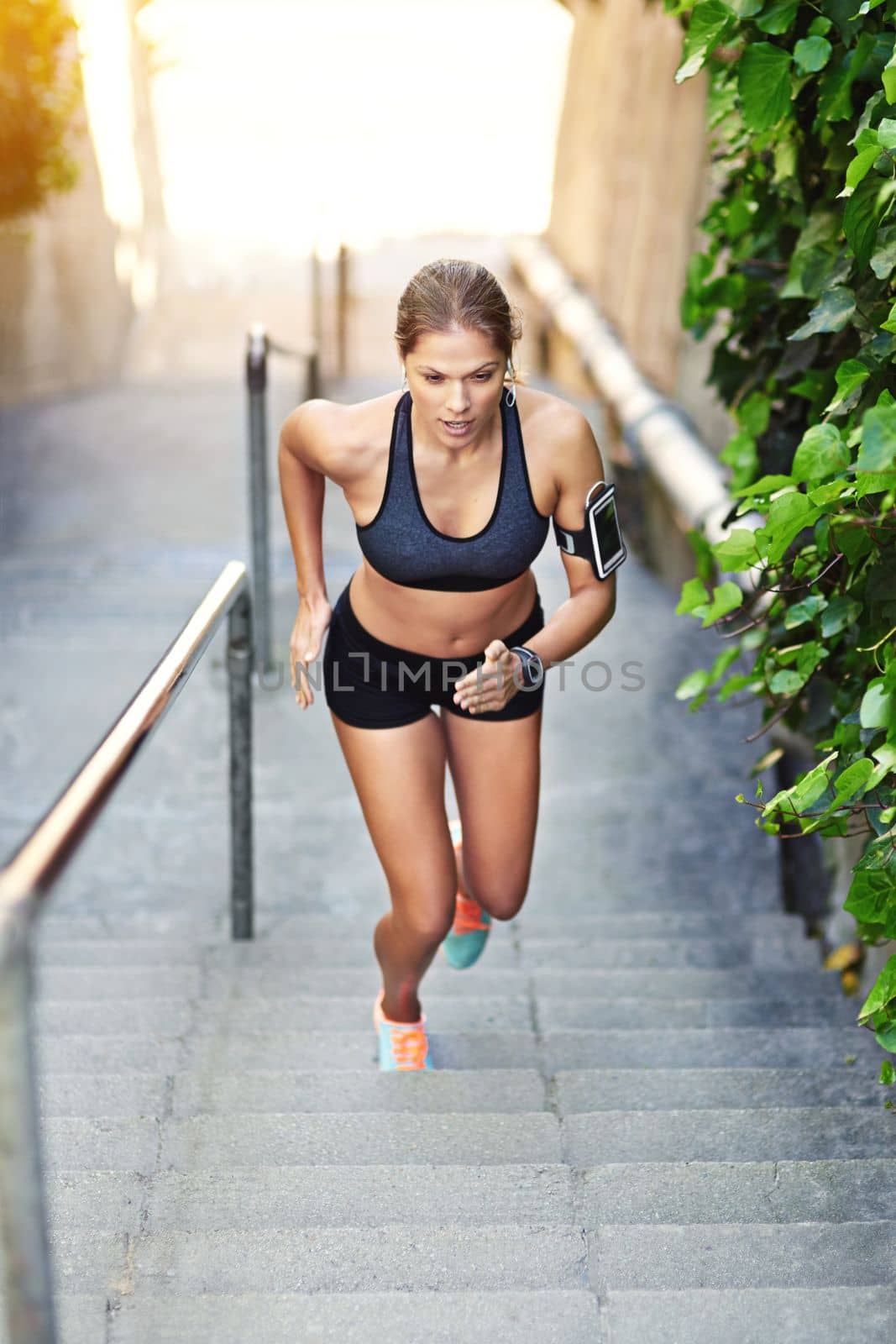 Stepping up her fitness. Full length shot of an attractive young athlete exercising outdoors. by YuriArcurs