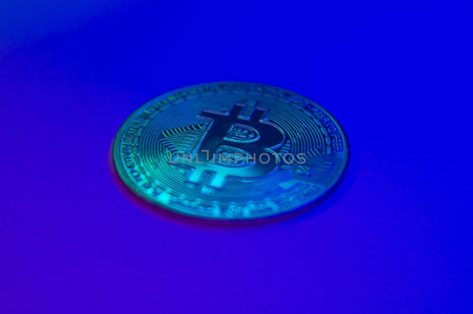 Crypto currency blue coin with bitcoin symbol on isolated on black background. Bitcoin Coin on colored background. Bitcoin cryptocurrency. Cryptocurrency Coin Concept. by mr-tigga