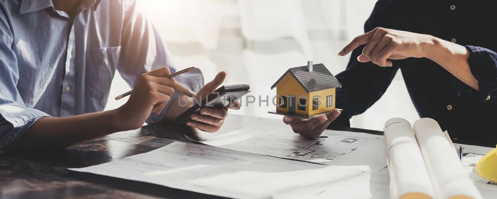 Civil engineer teams meeting working together wear worker helmets hardhat on construction site in modern city. Foreman industry project manager engineer teamwork. Asian industry professional team. by wichayada