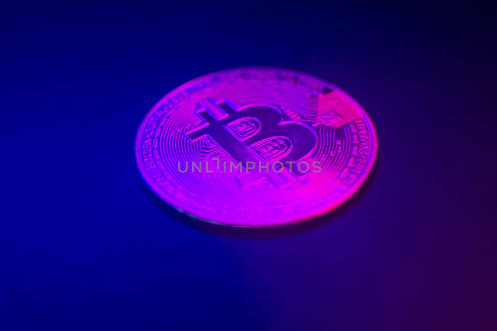 Crypto currency pink-golden coin with bitcoin symbol on isolated on black background. Bitcoin Coin on black background. Bitcoin cryptocurrency. Cryptocurrency Coin Concept. single golden valuable