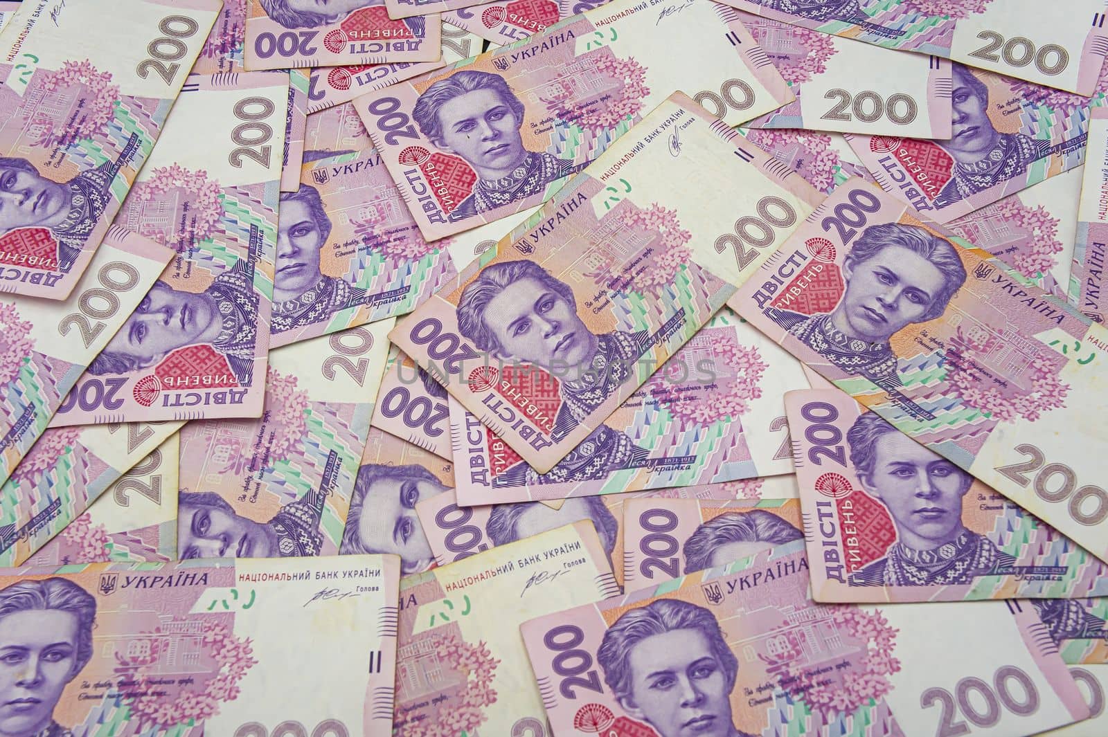 Ukrainian money background. banknotes with a face value of 200 hryvnia money background. Ukrainian money. Business concept. Background with hryvnia. Pink-blue
