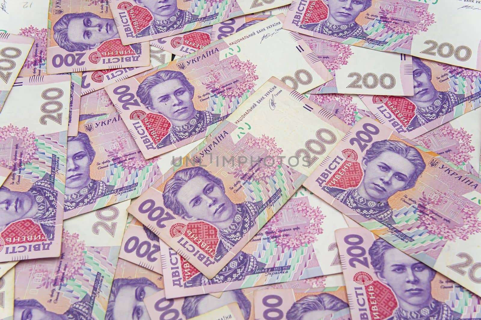 Ukrainian money background. banknotes with a face value of 200 hryvnia money background. Ukrainian money. Business concept. Background with hryvnia. Pink-blue