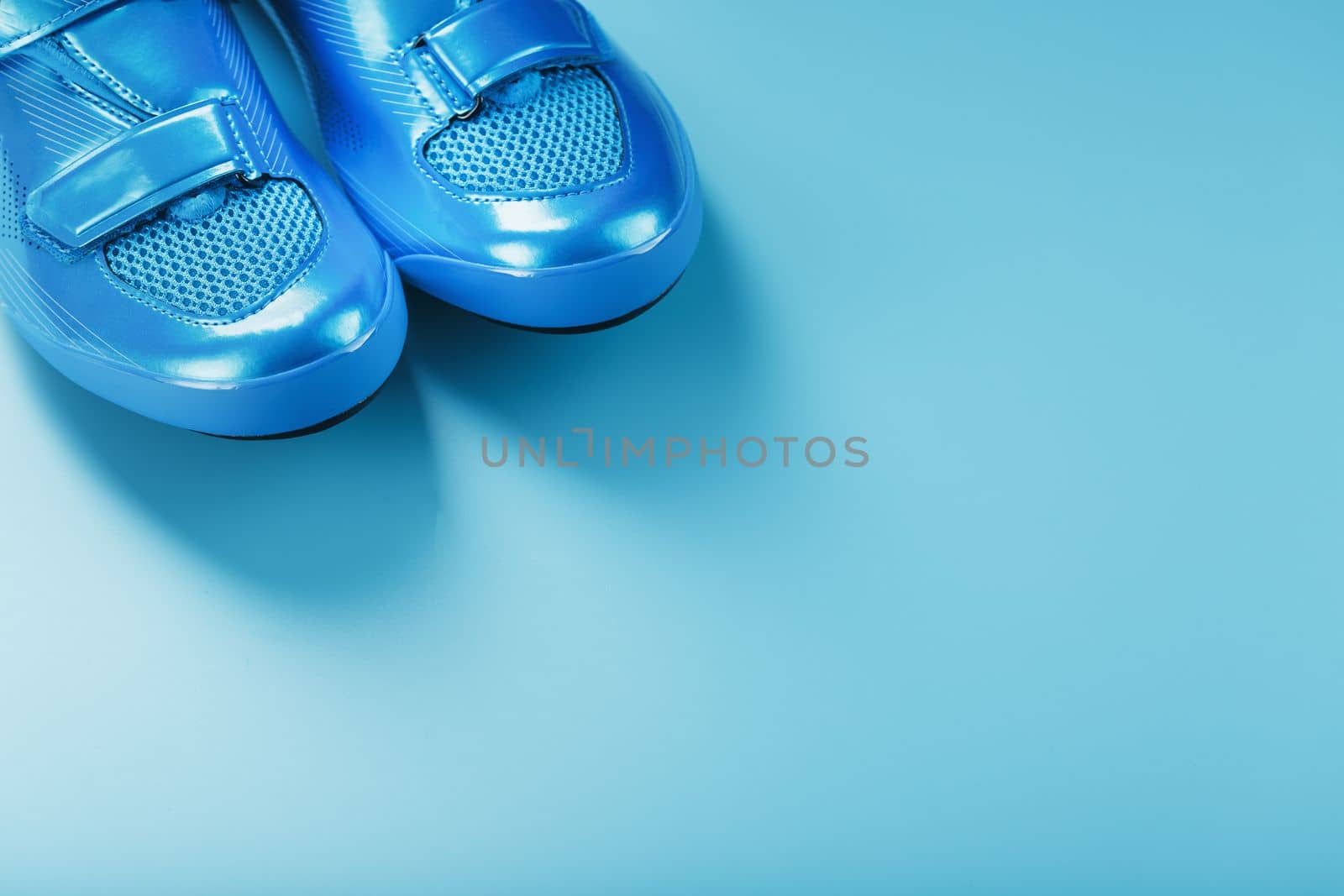 Blue Shiny Bicycle Shoes for Road Bike on Blue Background