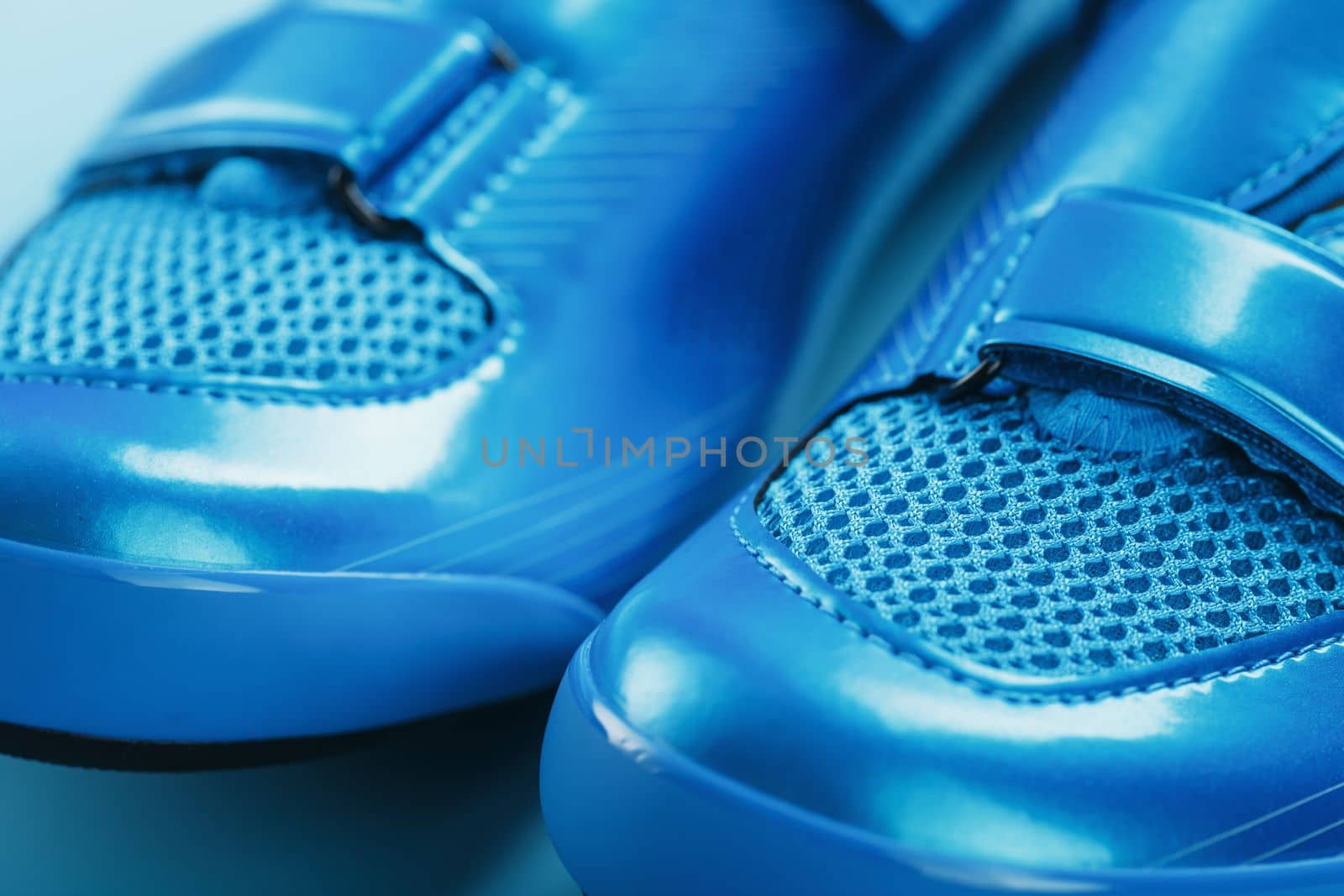 Blue Shiny Bicycle Shoes for Road Bike on Blue Background