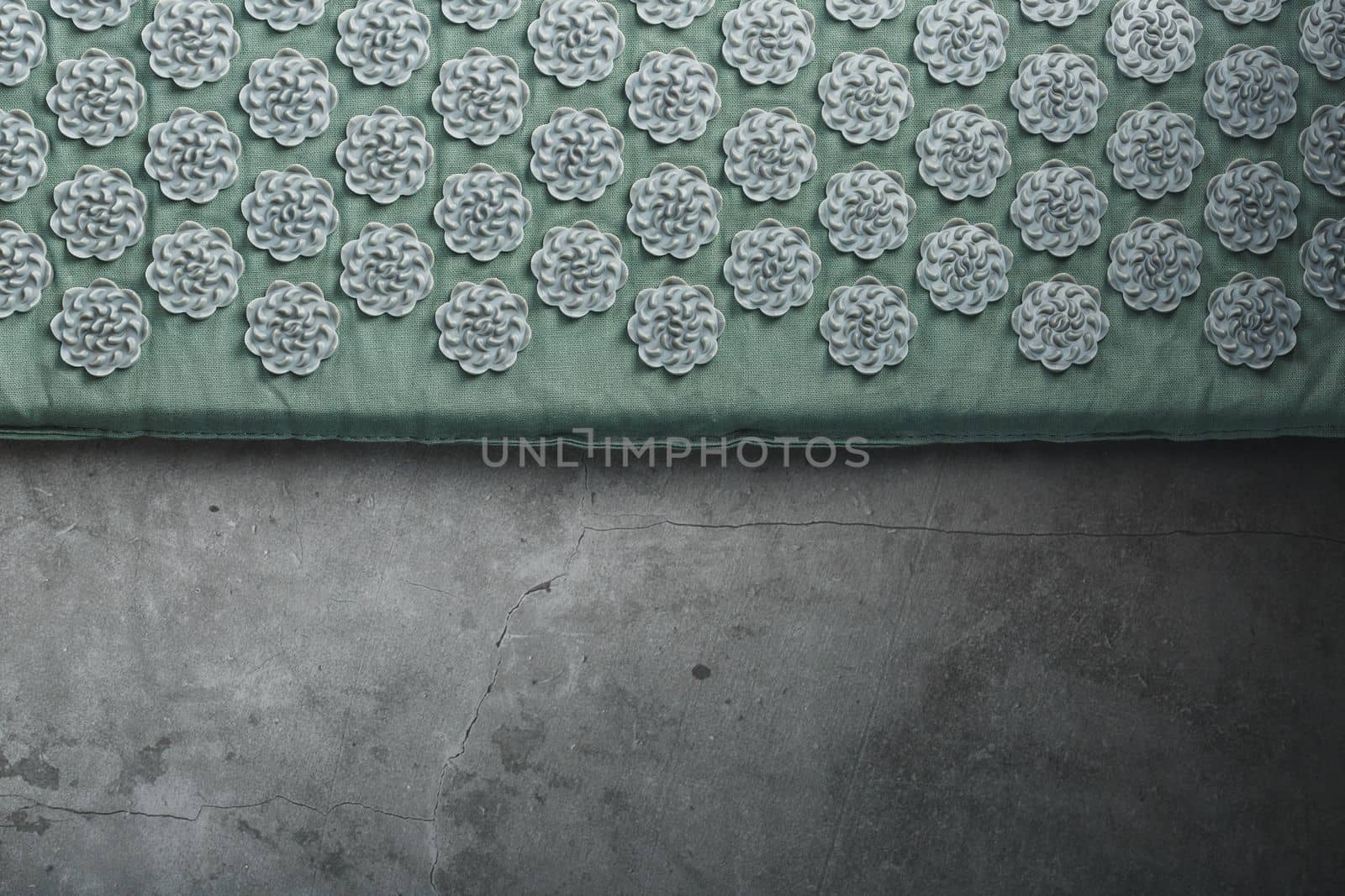 Massage mat with prickly spikes Kuznetsov applicator top view. On a gray background with free space