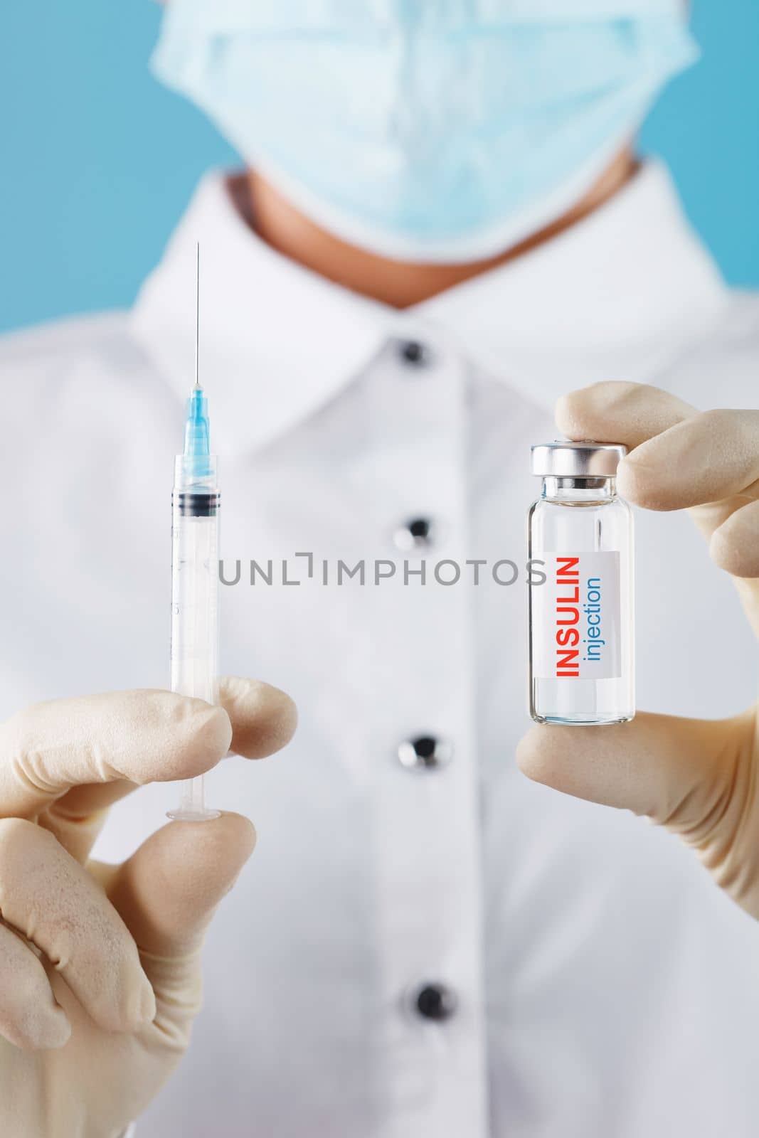 The doctor holds a syringe for injections and an ampoule with insulin for the treatment of Diabetes by AlexGrec