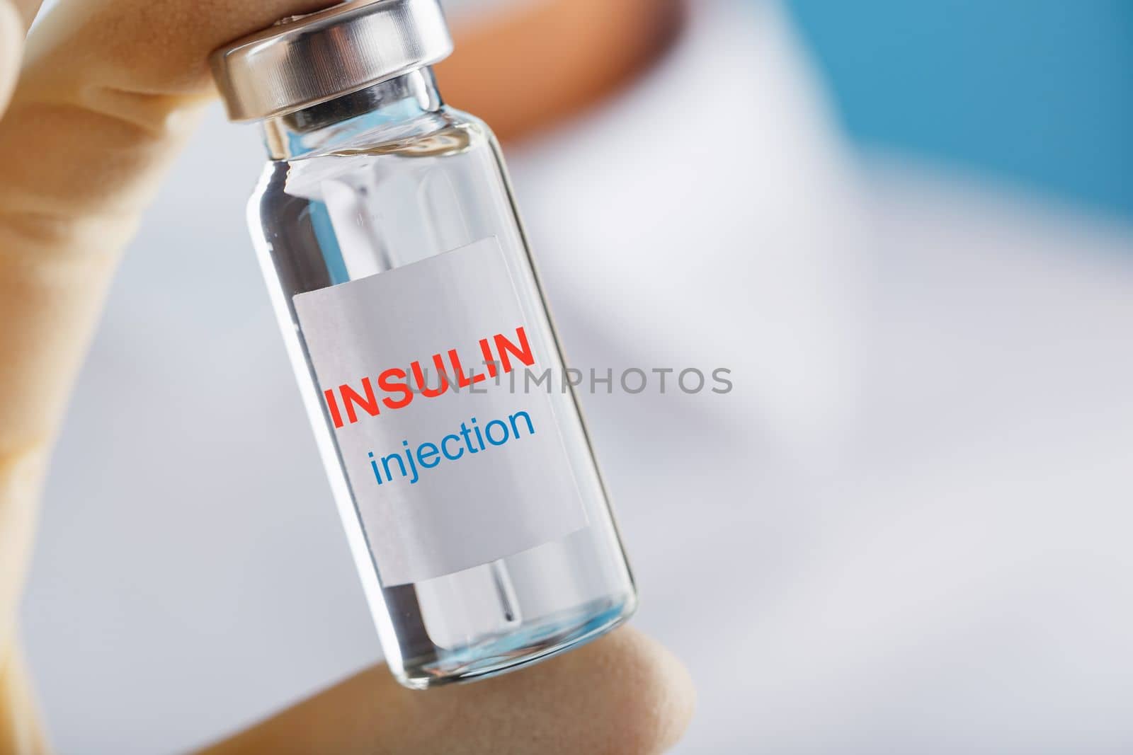 The doctor holds a syringe for injections and an ampoule with insulin for the treatment of Diabetes by AlexGrec