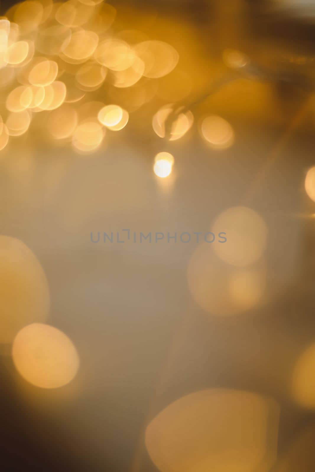 abstract shiny gold background. blured bokeh glowing golden background for design with copyspace. Shiny illumination lights by paralisart