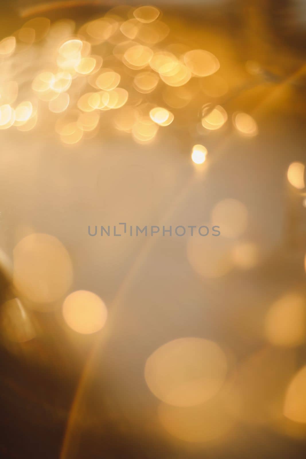 abstract shiny gold background. blured bokeh glowing golden background for design with copyspace. Shiny illumination lights by paralisart