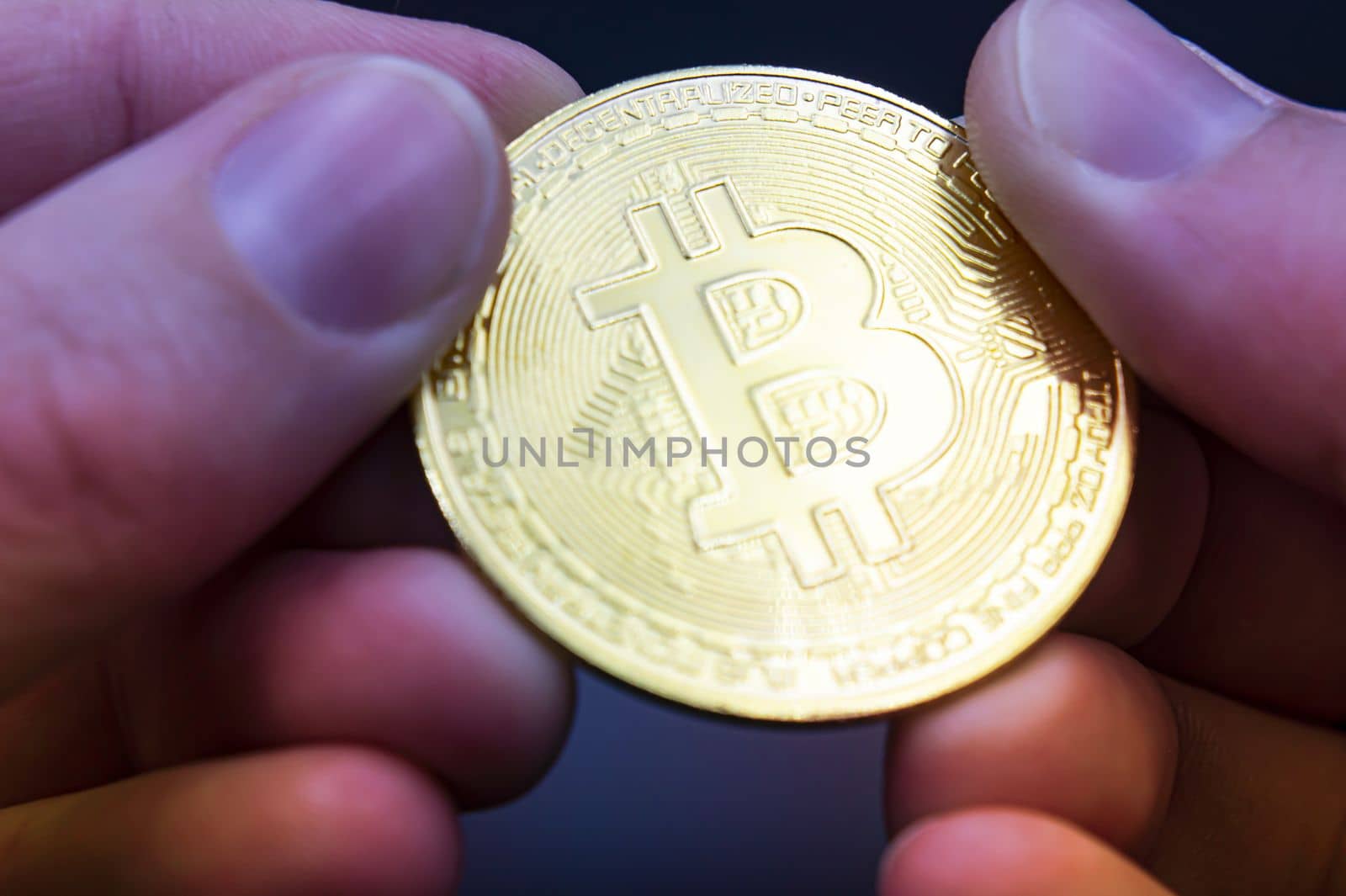Bitcoin transfer concept from hand to hand. High quality photo. Finger hold bitcoin golden on black isolated. Hand hold gold bitcoin crypto digital money concept. by mr-tigga