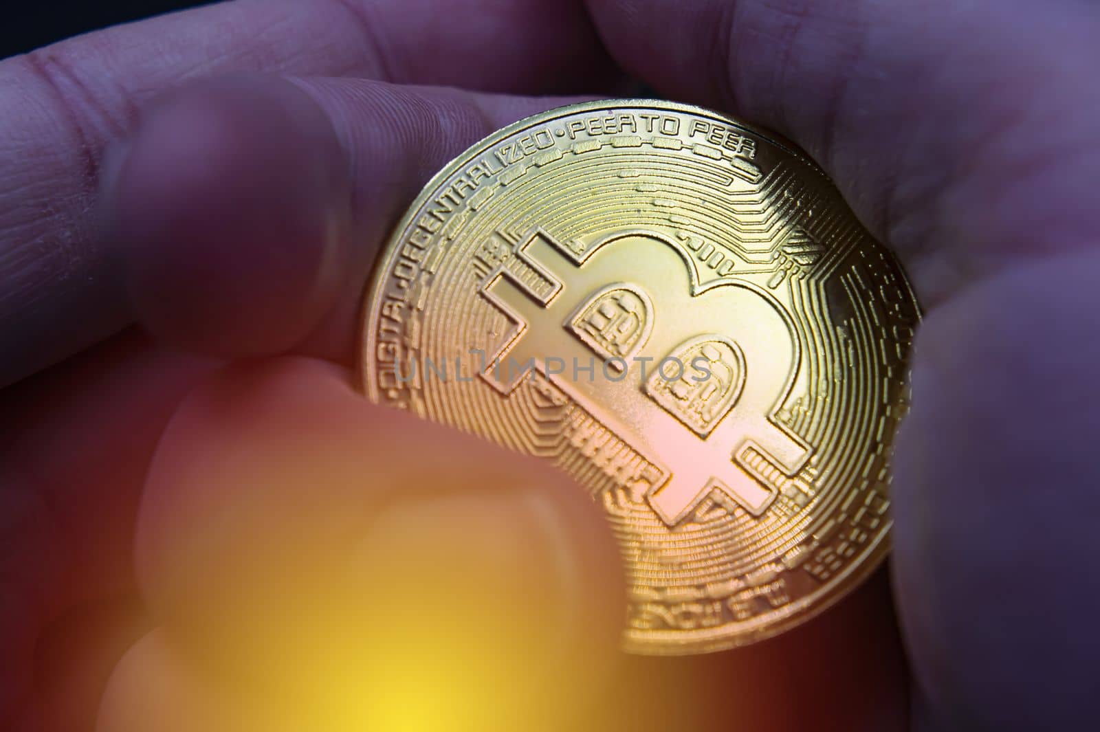 Finger hold bitcoin golden on black isolated. Hand hold gold bitcoin crypto ditital money concept. On a black background we look at a virtual currency, namely the cryptocurrency bitcoin, held in the right mine photo