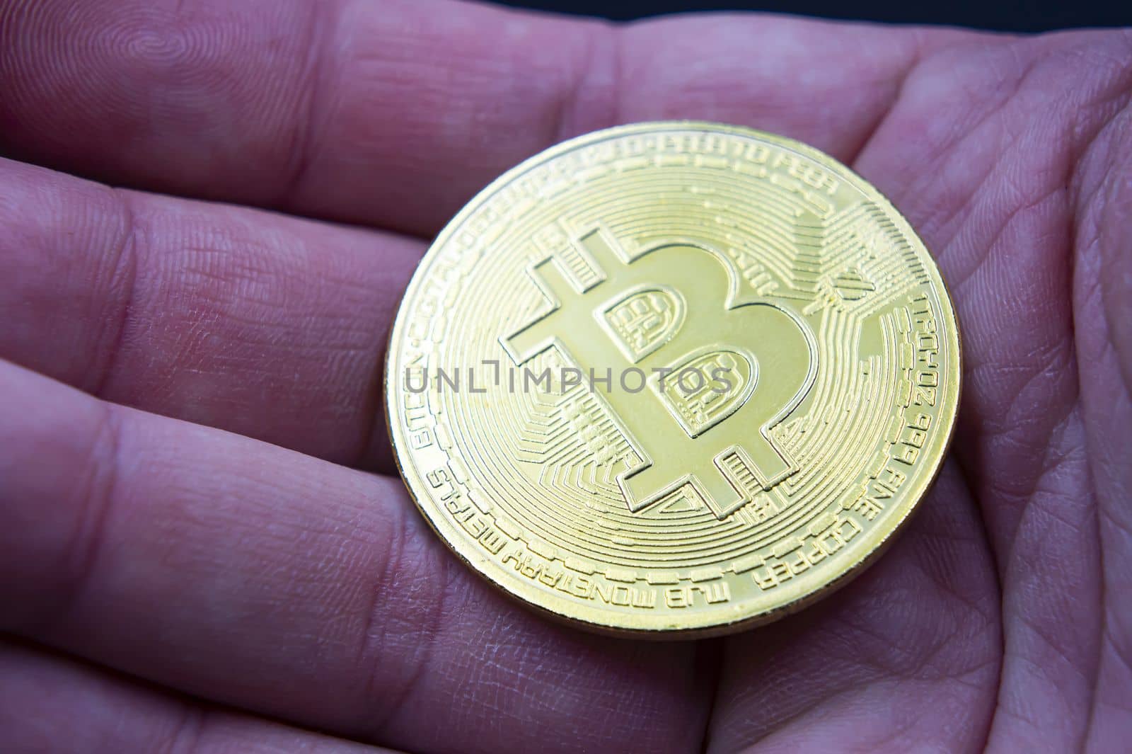Finger hold bitcoin golden on black isolated. Hand hold gold bitcoin crypto ditital money concept. On a black background we look at a virtual currency, namely the cryptocurrency bitcoin, held in the right mine. by mr-tigga