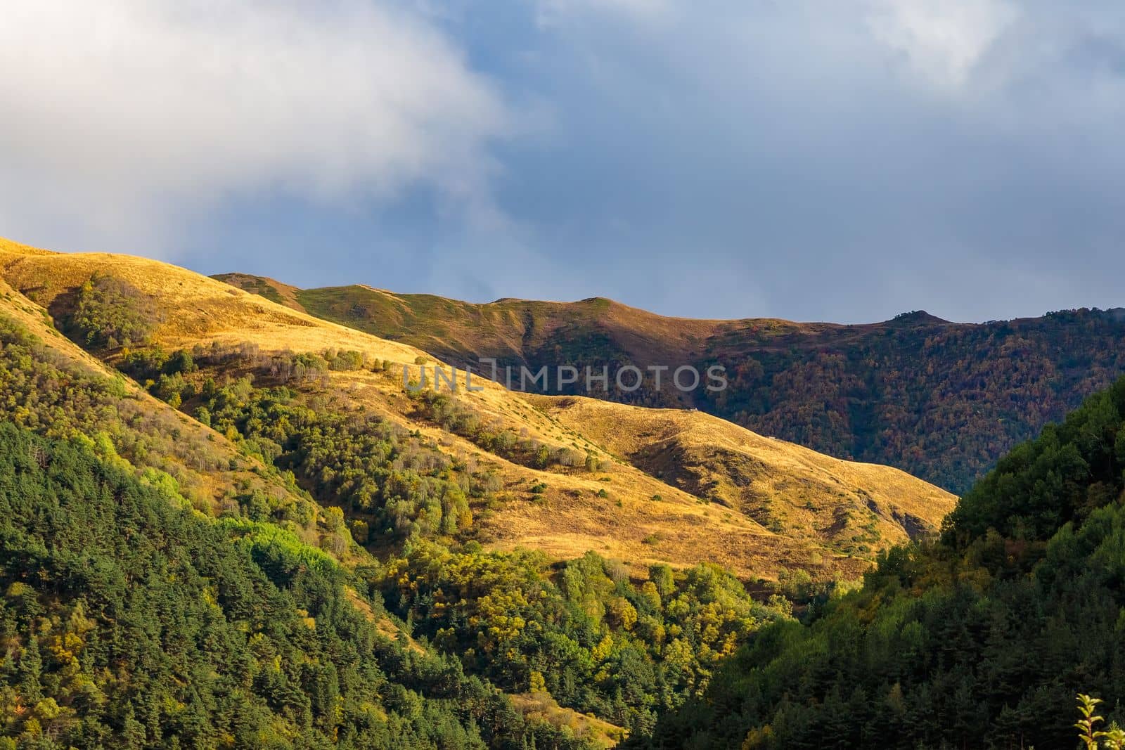 Highlands of North Ossetia. Mountains of the Caucasus. High mountains in the rays of the setting sun