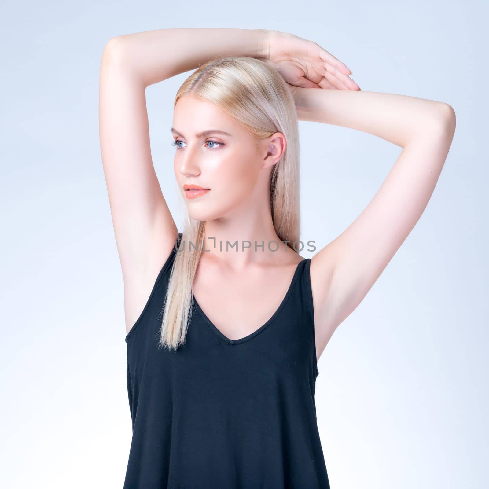 Personable woman lifting her armpit showing clean and hygiene underarm. by biancoblue