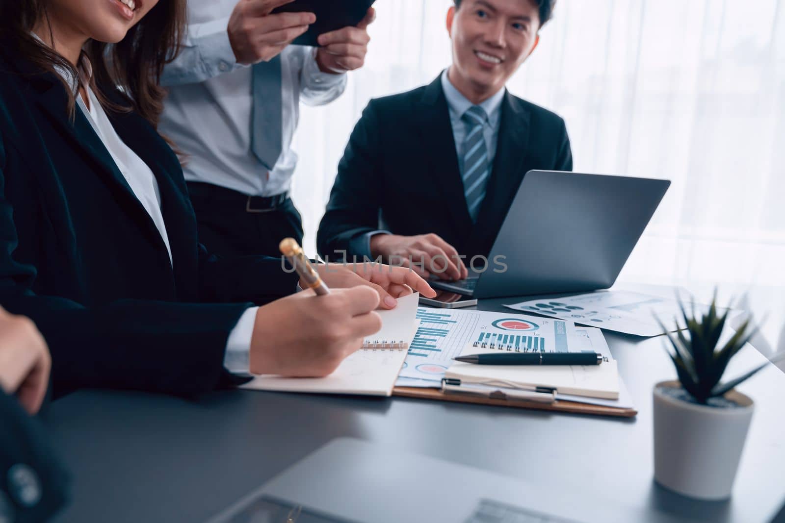 Closeup business team of financial data analysis meeting with business intelligence, report paper and dashboard on laptop for marketing. Business people working together in harmony office.