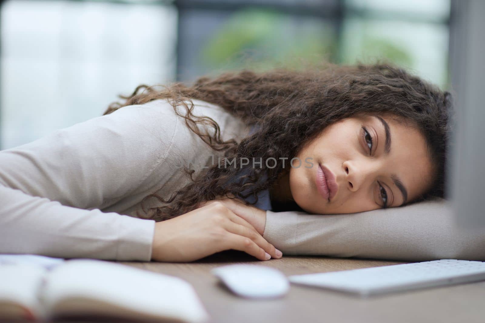 Portrait of a beautiful business woman sleeping on the table in the office