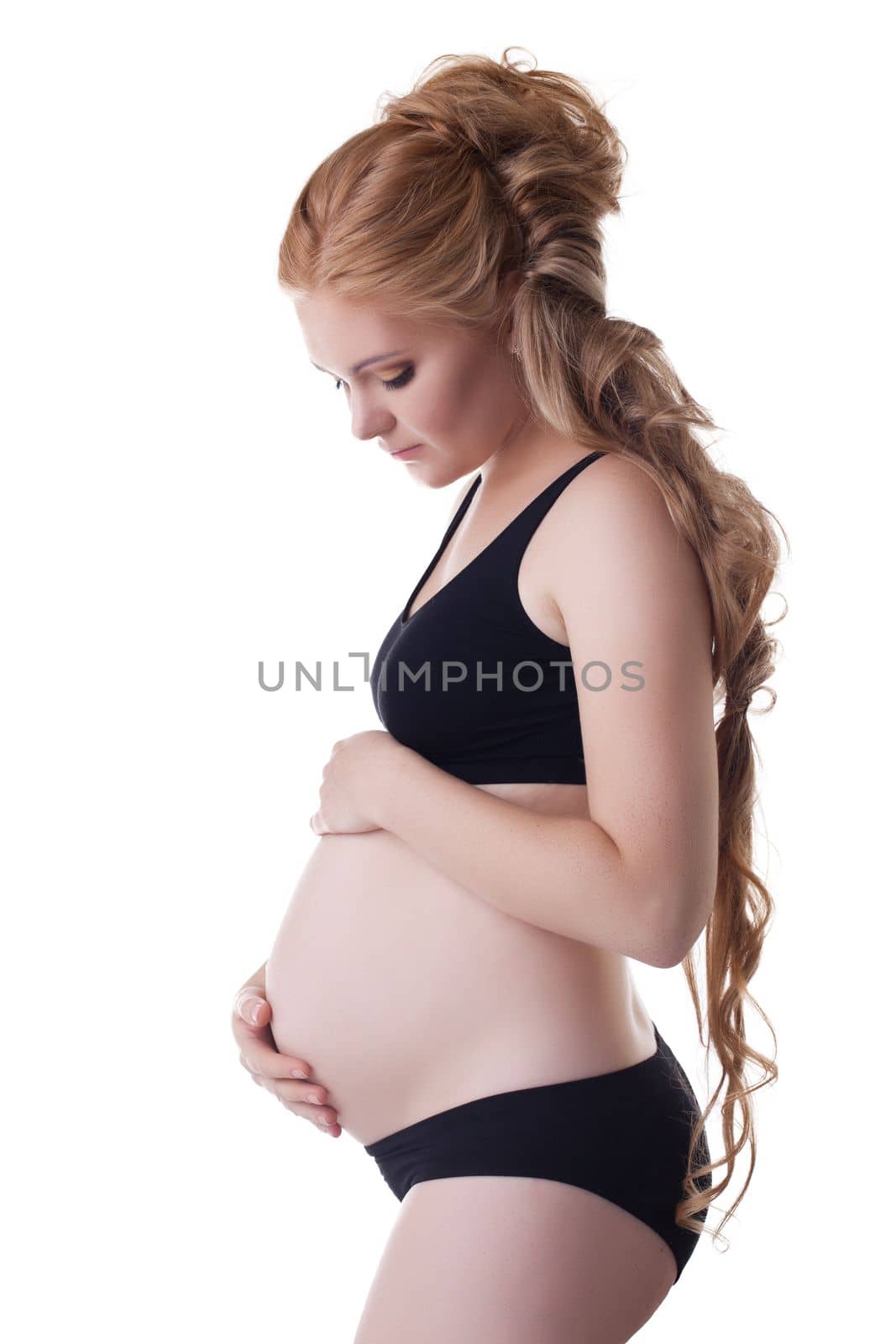 pretty pregnant woman portrait in black training cloth isolated