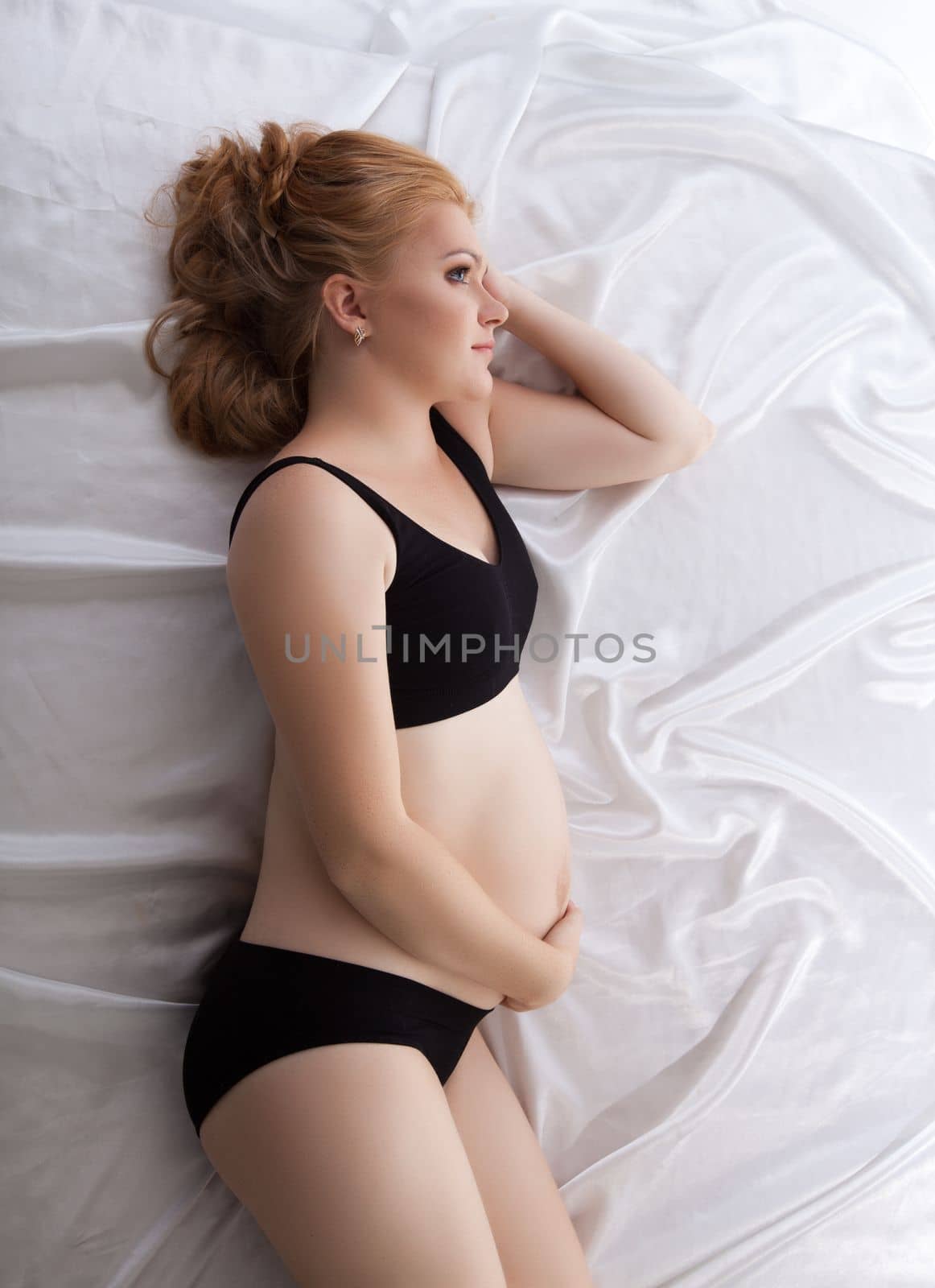 Beautiful young pregnant woman sleeping with long hairs