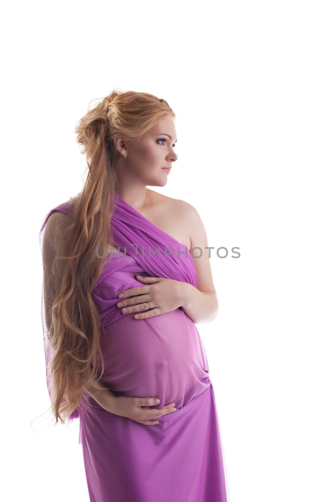 Young cheerful woman in pink fabric expect baby isolated
