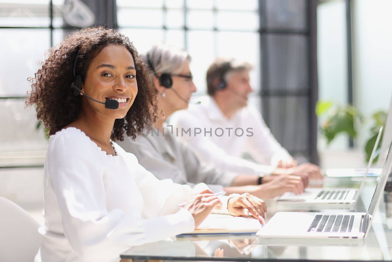 african american operator smiling in a call center.