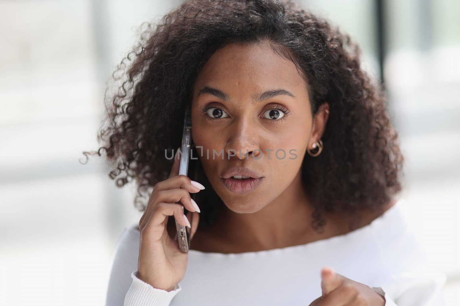 Portrait of a young African American woman talking on the phone