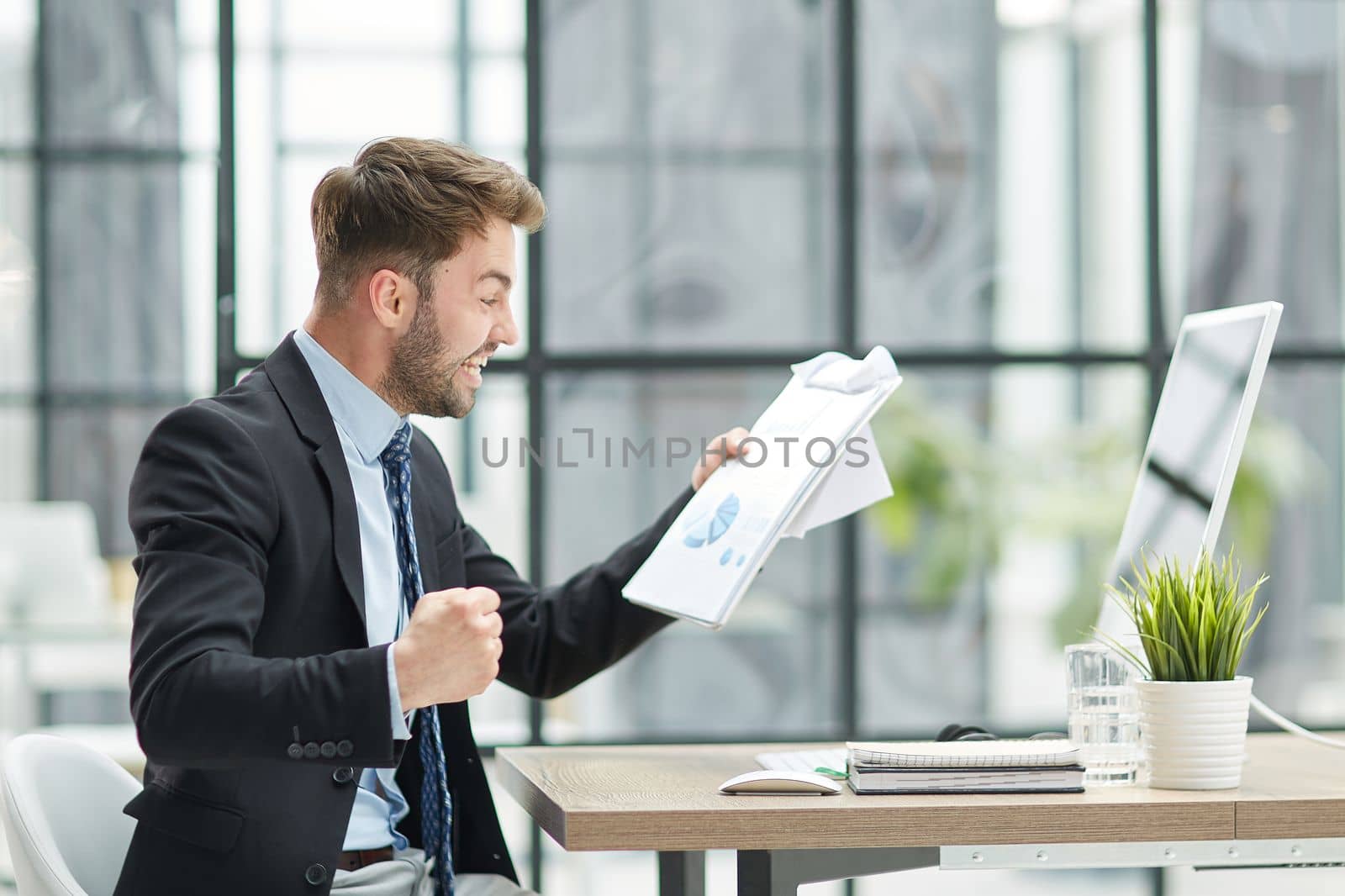 energetic businessman celebrating in office