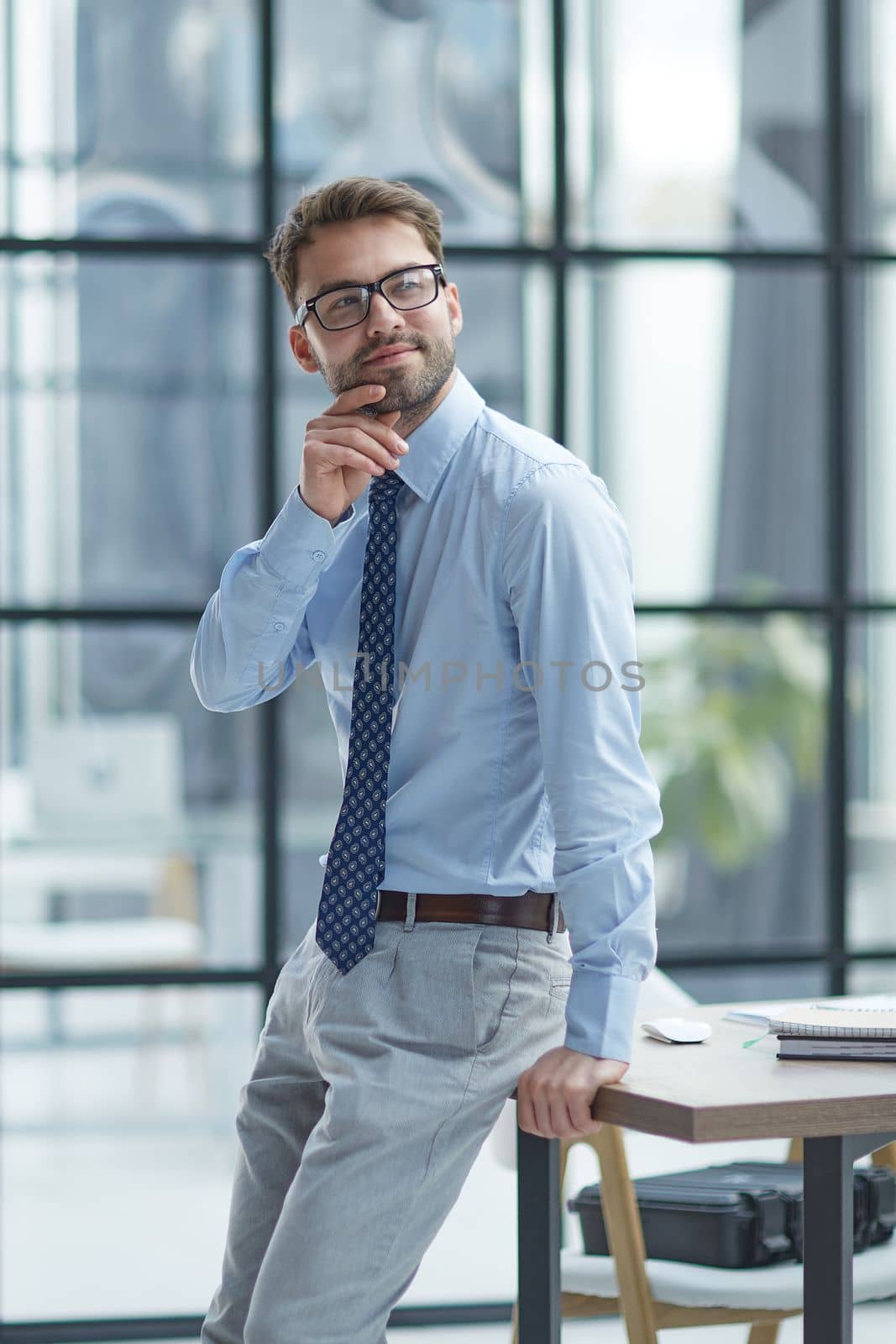 Young cheerful businessman working at office