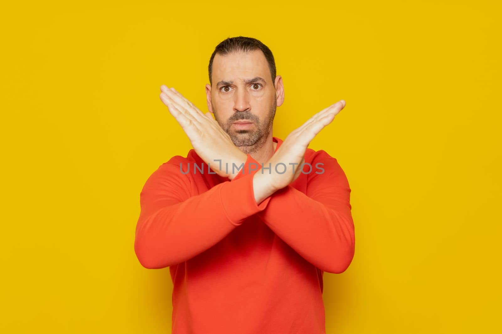 Bearded hispanic man wearing red jumper isolated keeping two arms crossed, denial concept.